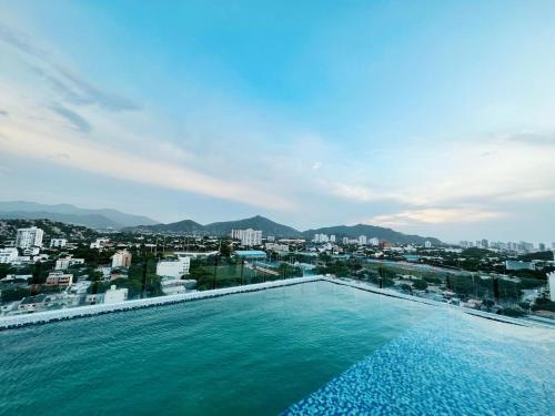 a swimming pool with a view of a city at Nuevo, amoblado y las mejores vistas de amaneceres in Santa Marta