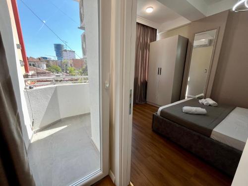 a small room with a bed and a window at City Center Cozy Apartment in Tirana