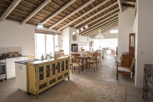 a kitchen and dining room with a table and chairs at Ashore - Beachfront Paradise in St Helena Bay