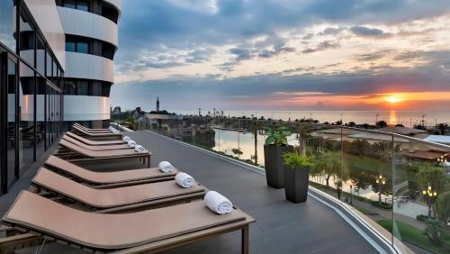 a row of lounges on the balcony of a building at Black Sea Luxury Apartment in Batumi