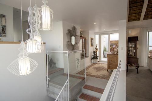 a staircase in a home with pendant lights at Ashore - Beachfront Paradise in St Helena Bay