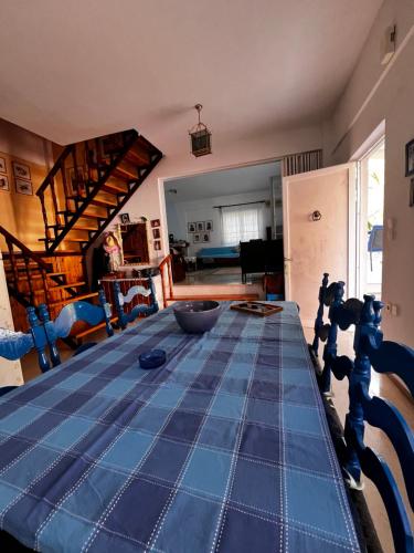 a dining room table with a blue table cloth on it at Anna's House in Kokkino Nero