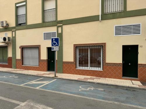 a street sign in front of a building at Orange Suite by Alhaurín Loft City Center in Alhaurín de la Torre