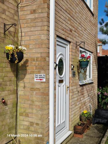 a house with a white door and a sign on it at The Annexe in Bridlington
