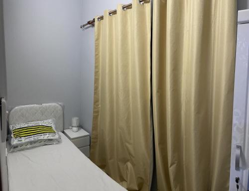 a bedroom with a bed and a shower curtain at Pharaohs Inn MOE Hostel in Dubai
