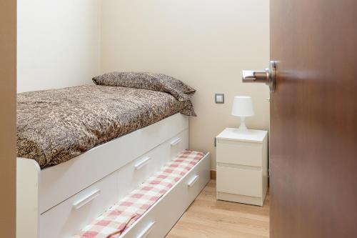ein Schlafzimmer mit einem Bett und eine Tür mit einer Schublade in der Unterkunft AndBnB I Balcón, Vistas y Naturaleza I Parking Gratuito in El Tarter