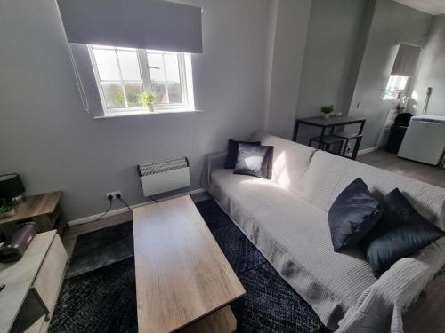 a living room with a white couch and a window at One Bedroom flat sittingbourne in Kent
