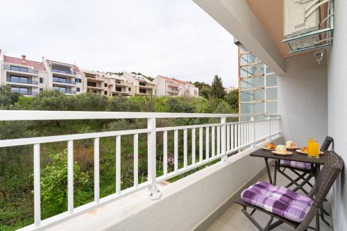 a balcony with a table and chairs on it at Star Apartments Dubrovnik in Dubrovnik