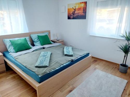 a bedroom with a bed with green pillows on it at Eni-Time Mariazell in Mariazell