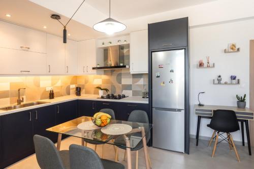 a kitchen with a table and a refrigerator at S&V Luxury Apartment in Sfakaki
