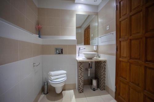 a bathroom with a toilet and a sink at Villa Samac in Trogir