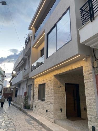 a building on a street with people walking past it at Estia Luxury Apartment in Ierápetra