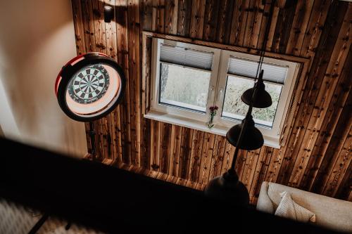 a room with a window and a clock on the wall at Coś miłego in Gowidlino