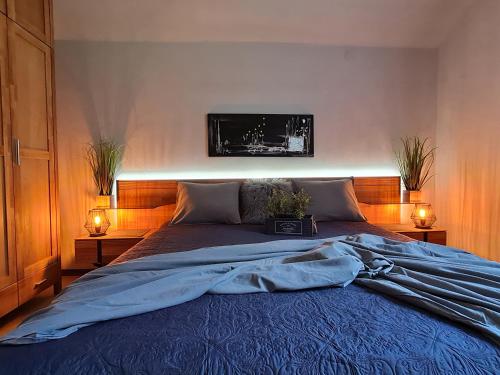 a bedroom with a large bed with two lights on it at Haus SaBo 