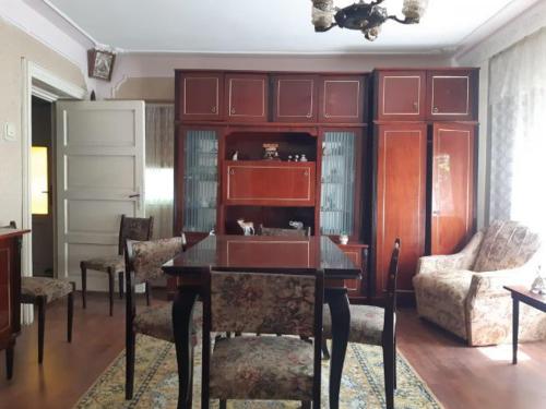 a living room with a table and chairs and a couch at Vila Codrin in Iaşi