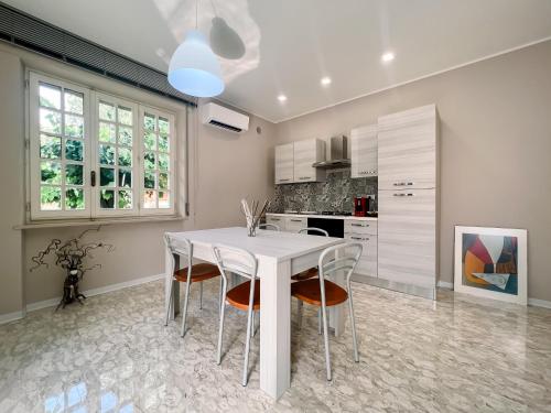 a white dining room with a white table and chairs at La Casa di Mary in Atessa