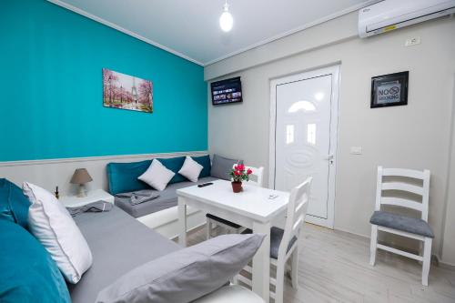 a living room with a couch and a table at Guest House Narta in Vlorë
