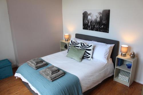 a bedroom with a bed with towels on it at Flat 5, Westhill in Leeds
