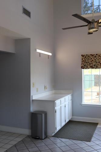 a white kitchen with a counter and a window at Woodstream Inn in Hogansville