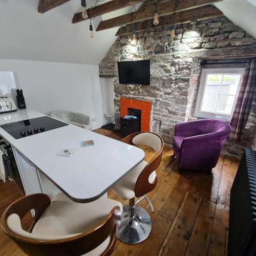 a living room with a white table and chairs at Ness City Cottage - Attic Apartment in Inverness