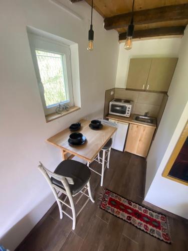a small kitchen with a table and chairs in a room at Kras village 