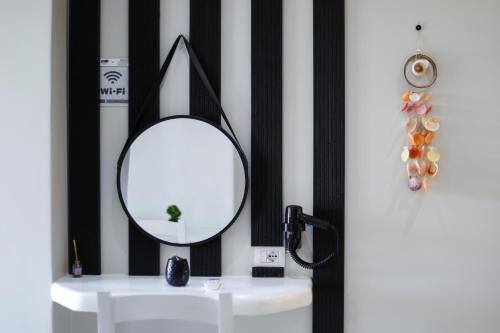 a mirror sitting on top of a white table at Guest House Narta in Vlorë
