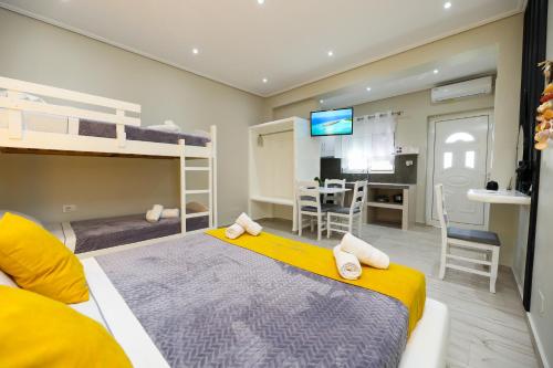 a bedroom with two bunk beds and a dining room at Guest House Narta in Vlorë