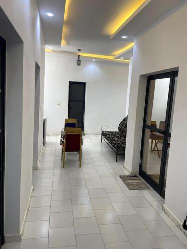a hallway with a room with a couch and a chair at Résidence Daldiam in Thiès
