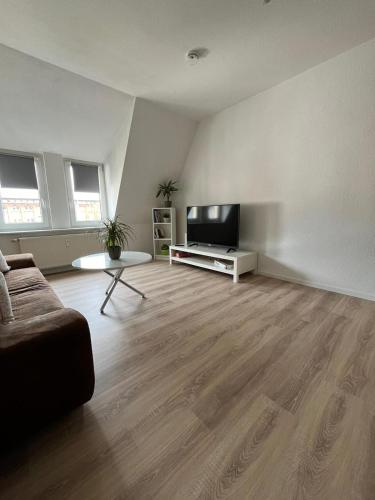 a living room with a flat screen tv and a couch at 1 Raum Wohnung in ruhiger Lage in Limbach-Oberfrohna