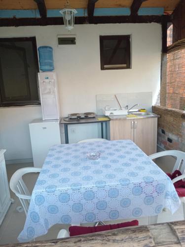 a kitchen with a blue and white table and chairs at Apartmani Primus in Bosanska Gradiška