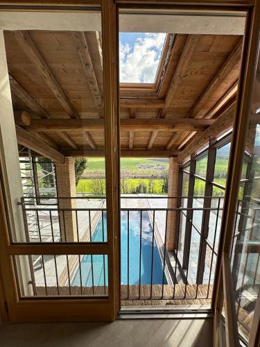 a room with a large window with a view at La Valle del Re - Agriturismo in Medesano