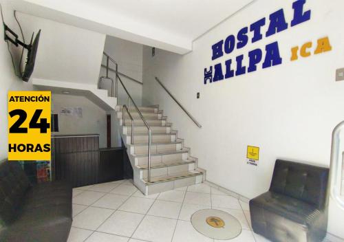 a lobby with stairs and a sign on the wall at Hallpa Ica in Ica