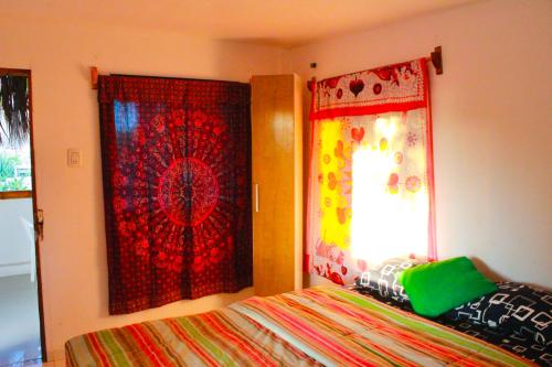 a bedroom with a bed and a window at Fundo El Cortarrama in Talara