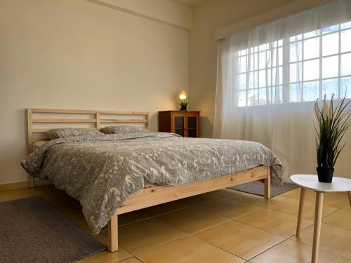 a bedroom with a bed and a large window at STUDIO in Limassol