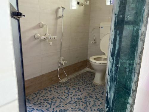 a bathroom with a shower with a toilet at OYO Flagship My Home in Mire