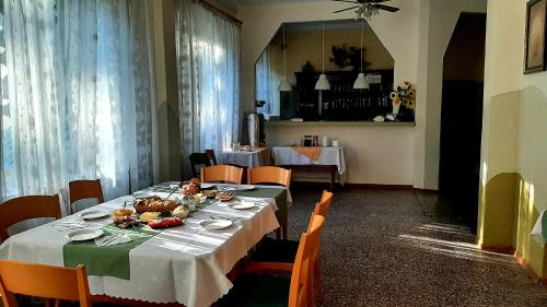 a dining room with a table with food on it at Leśny Zajazd in Susiec