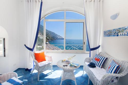 a living room with a view of the ocean at Casa Oceano in Positano