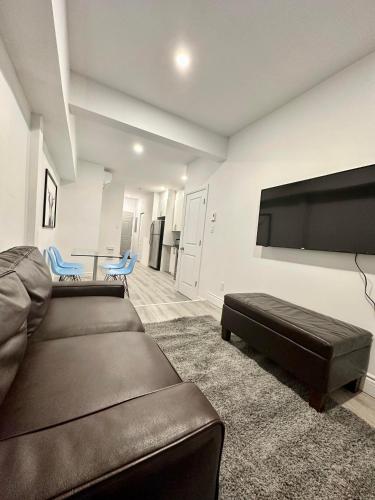 a living room with a couch and a flat screen tv at Appartement 1 chambre - 101 in Montréal