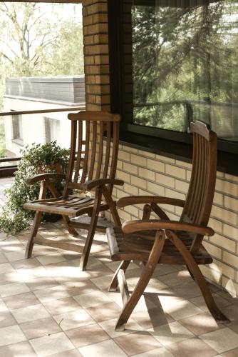 two wooden rocking chairs sitting on a porch at Hotel Fjalar in Salo