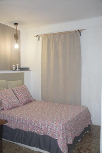 a bedroom with a bed with a pink bedspread at Habitación delante de la playa Blanes in Blanes