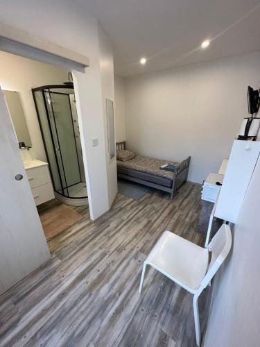 a room with a bed and a chair in it at Appart O'key in Lure