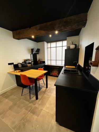 - une cuisine avec une table, une table et des chaises dans l'établissement Maison suspendue avec jacuzzi privatif, à Pont-en-Royans