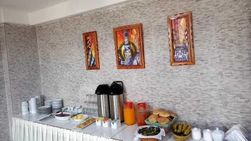 a kitchen counter with pictures on the wall at Santa Catalina Hotel Cusco in Cusco