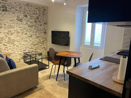 a living room with a couch and a table at MORINGA - New unit for 2 AC close to beach in Antibes