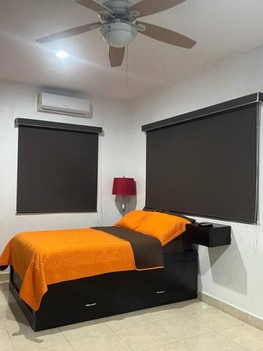 a bedroom with a bed and a ceiling fan at Estudio Luxury Room in Chetumal