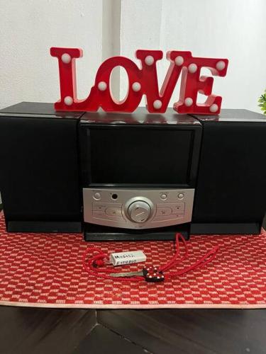 a sign that says love sitting on top of a microwave at Estudio Luxury Room in Chetumal