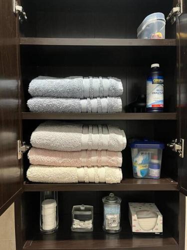 a shelf with towels and other items in a closet at Estudio Luxury Room in Chetumal