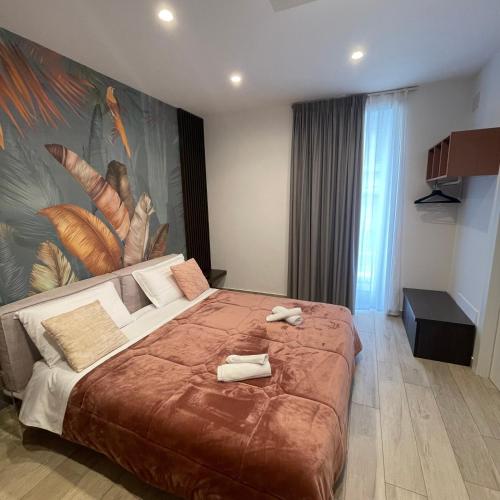a bedroom with a large bed with towels on it at Namuri Luxury Rooms in Taormina
