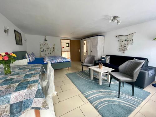 a living room with a bed and a couch at Ferienwohnungen Rolinski in Lietzow