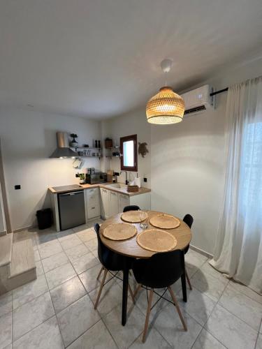 a dining room with a table and chairs in a kitchen at Olea White in Skiathos Town